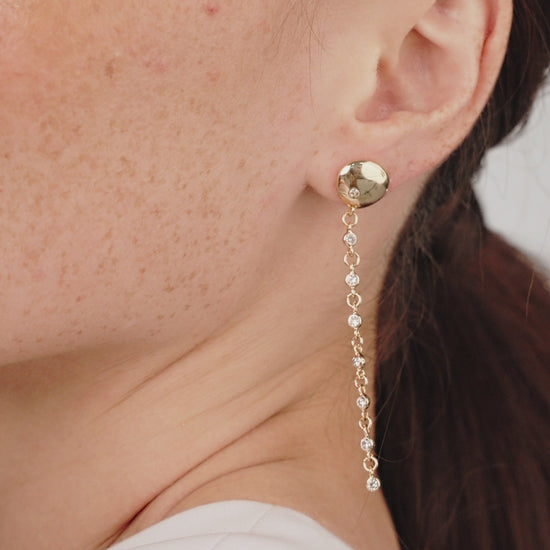 Polished Pebble Linear Crystal Chain Drop Earrings in gold on model in video