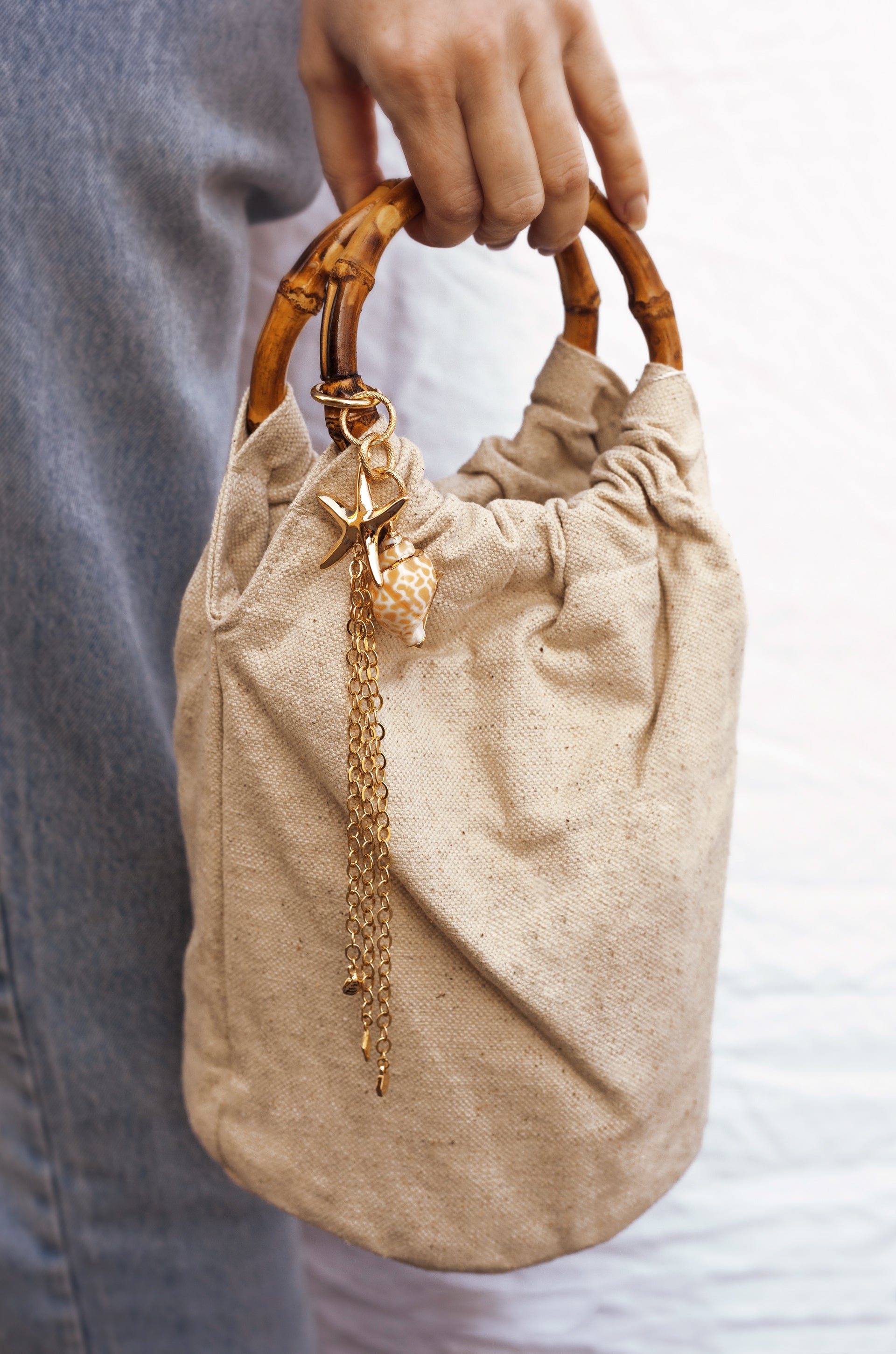 Beige Bucket Bag with Starfish & Shell Tassel shown on a model