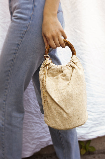 Beige Bucket Bag with Starfish & Shell Tassel shown on a model 2
