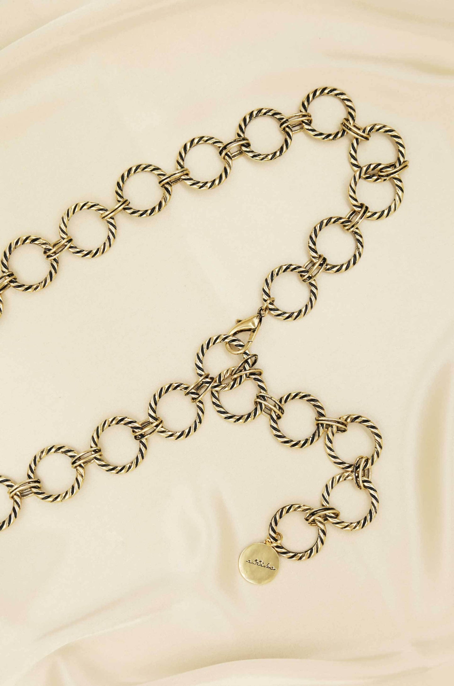 Loop It Through Belt in Antique Gold on slate background  