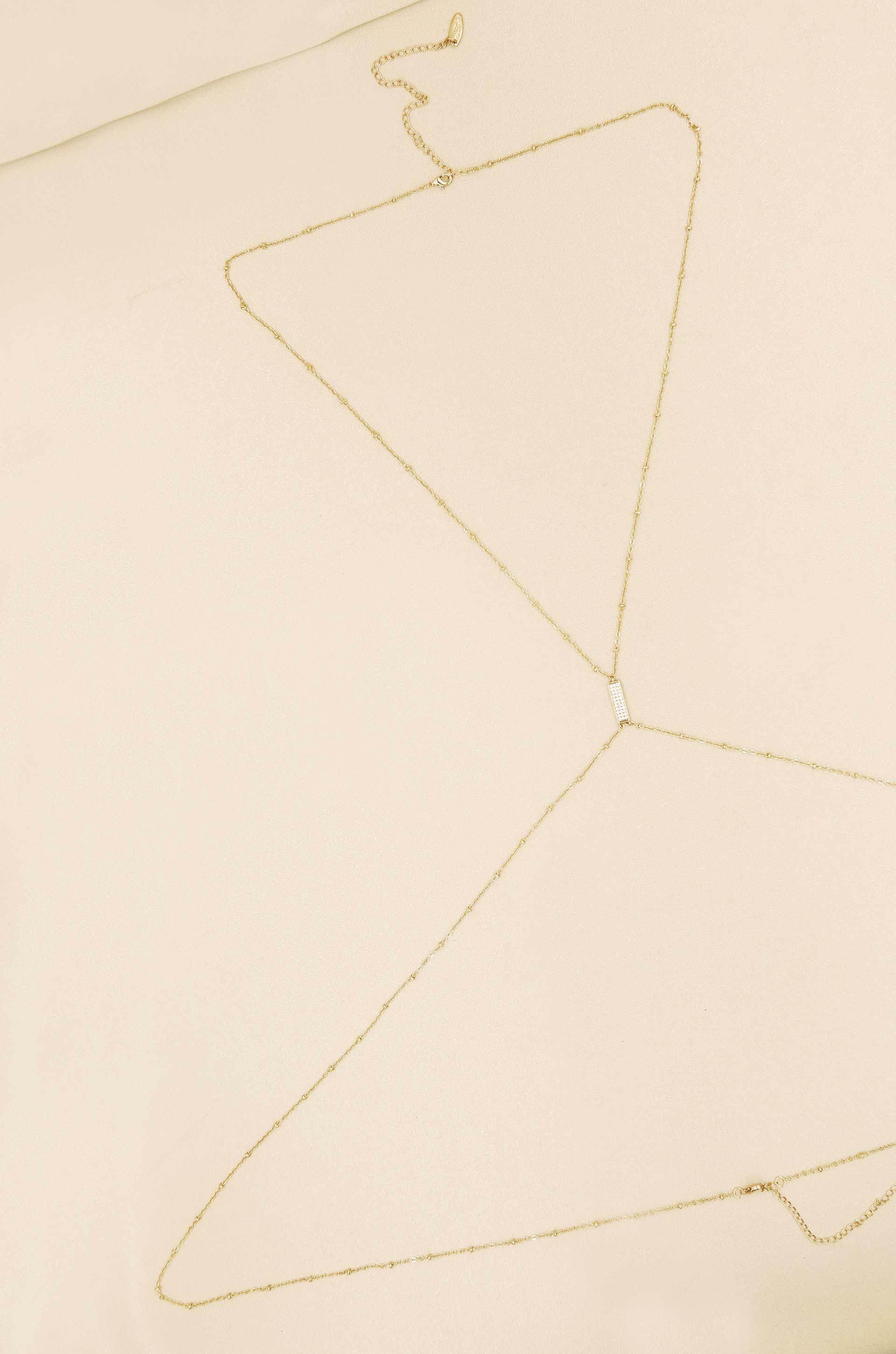 Sun Searcher Body Chain in Gold on slate background  