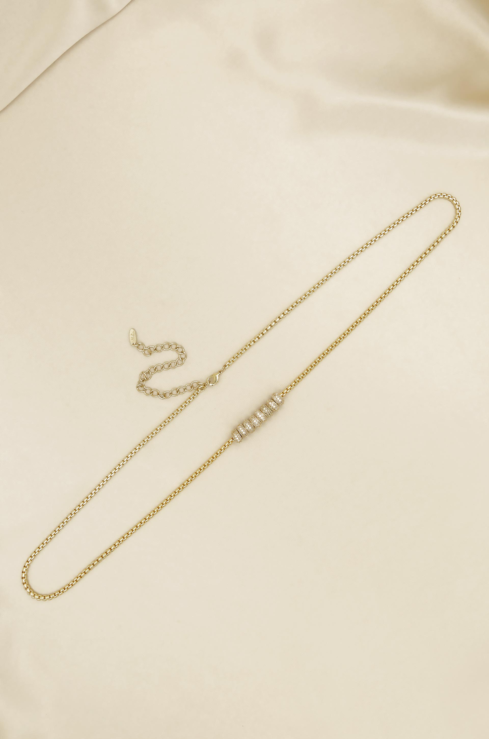 Single Strand Gold Plated Body Chain on slate background  