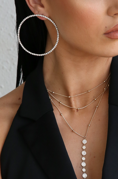 Picture Perfect Crystal Circle 18k Gold Plated Earrings shown on a model  