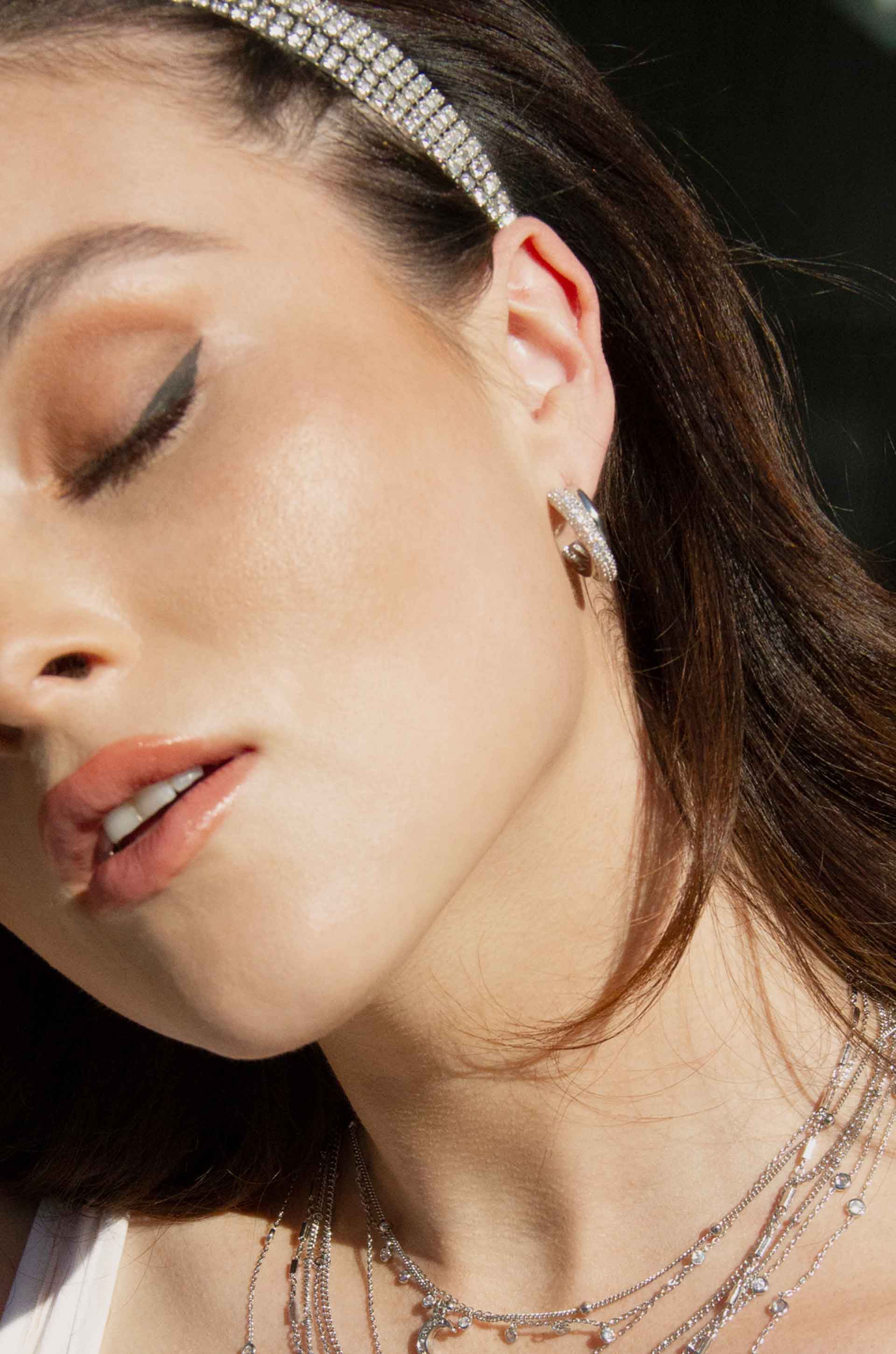 Crystal Intertwined Small Hoop Earrings shown on a model  2