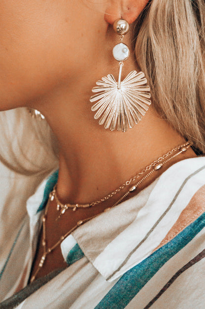 Palm Leaf Earring with Pearl in Gold shown on a model 2