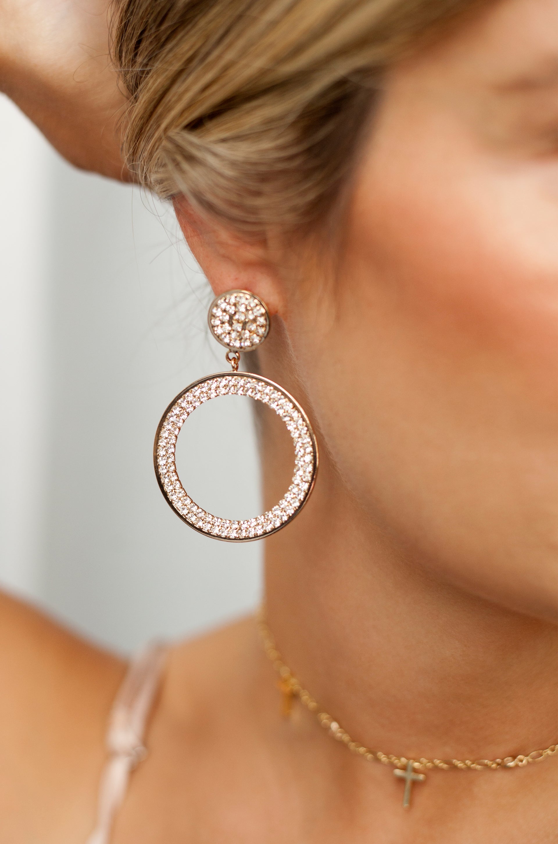 Crystal Pave 18k Gold Plated Drop Hoop Earrings shown on a model  