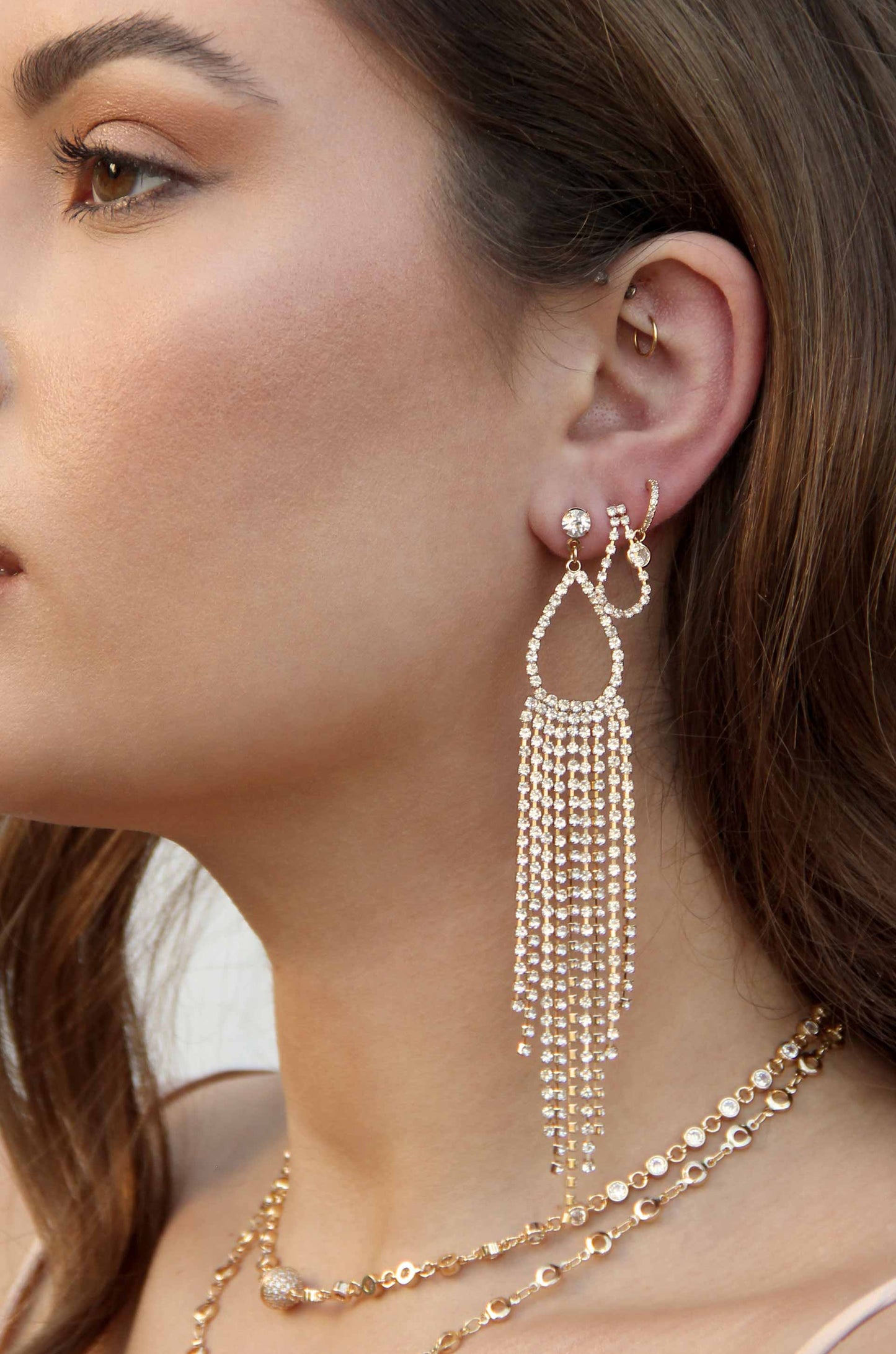 Long Teardrop Crystal Chandelier 18k Gold Plated Earrings shown on a model  