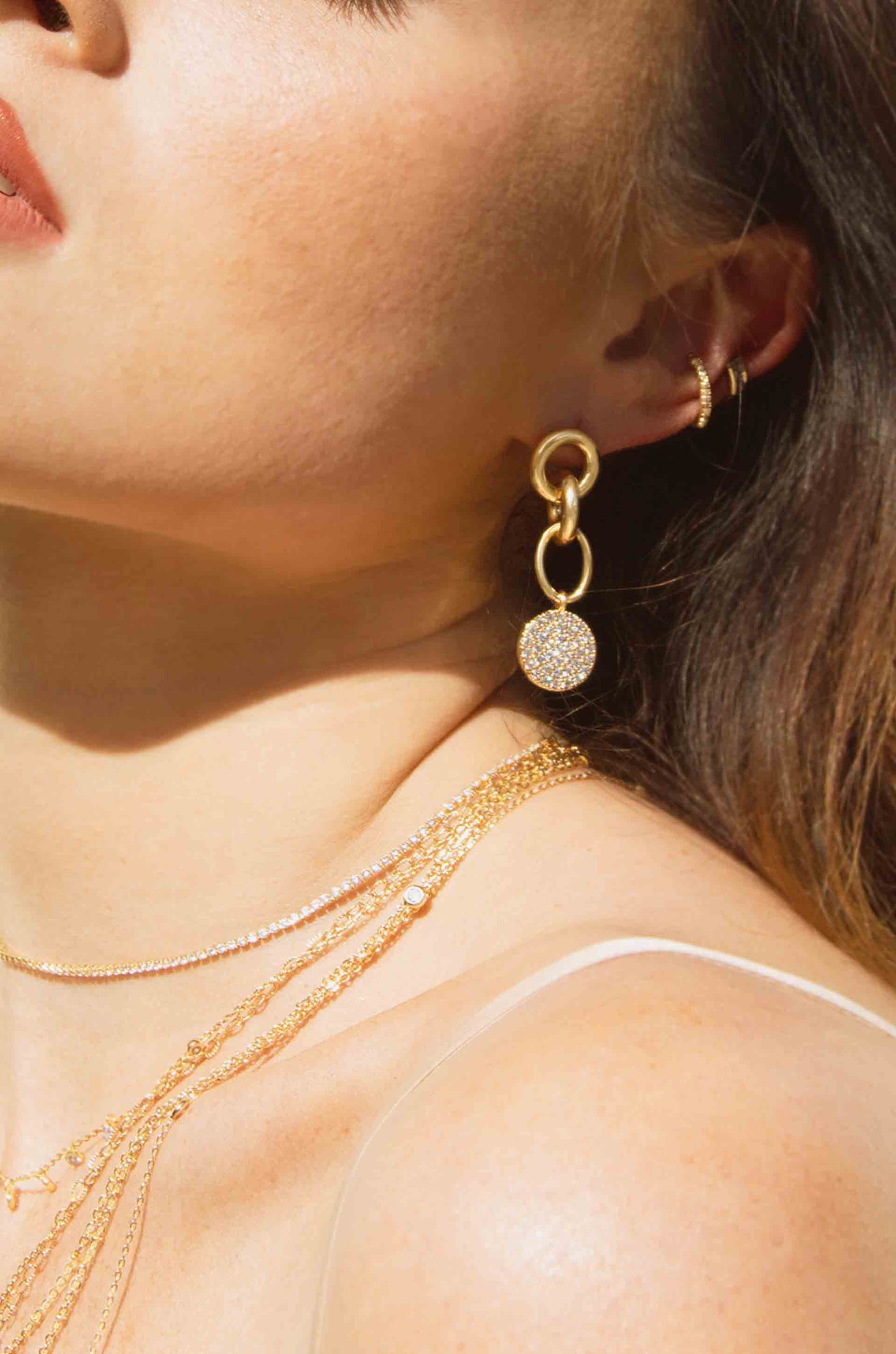 Dangle Crystal Disc 18k Gold Plated Earrings shown on a model  