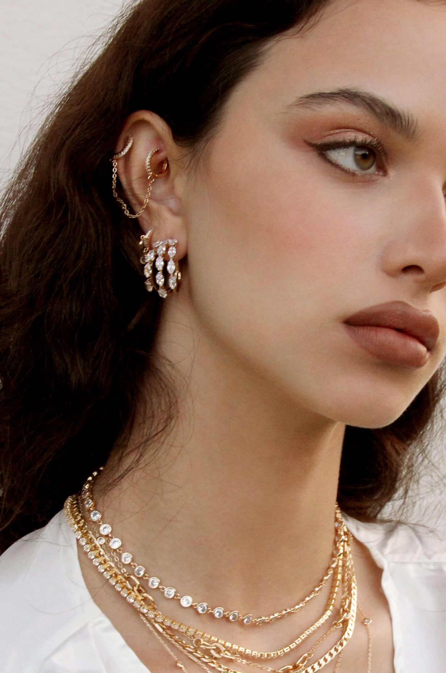 Multi-Crystal Huggie 18k Gold Plated Hoop Earrings shown on a model  