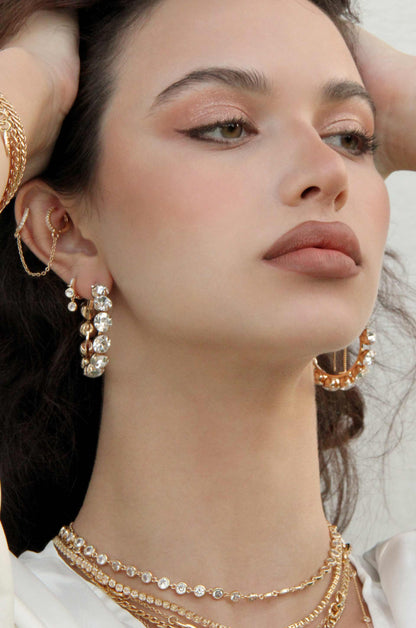 Small Crystal & 18k Gold Warrior Hoop Earrings shown on a model  