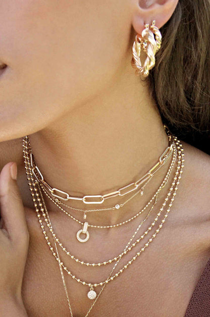 Modern Day 18k Gold Plated Twist Hoops shown on a model  