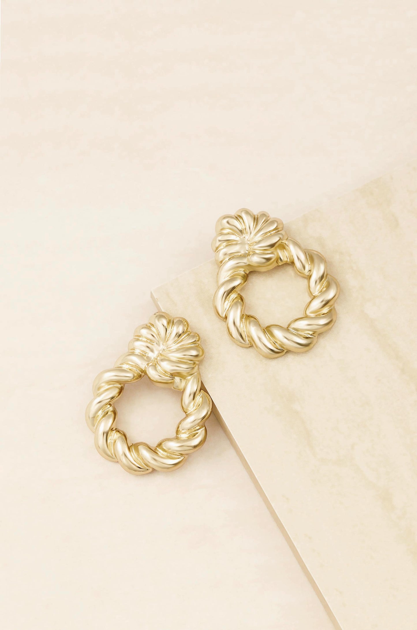 Twist and Shout 18k Gold Plated Textured Earrings on slate background