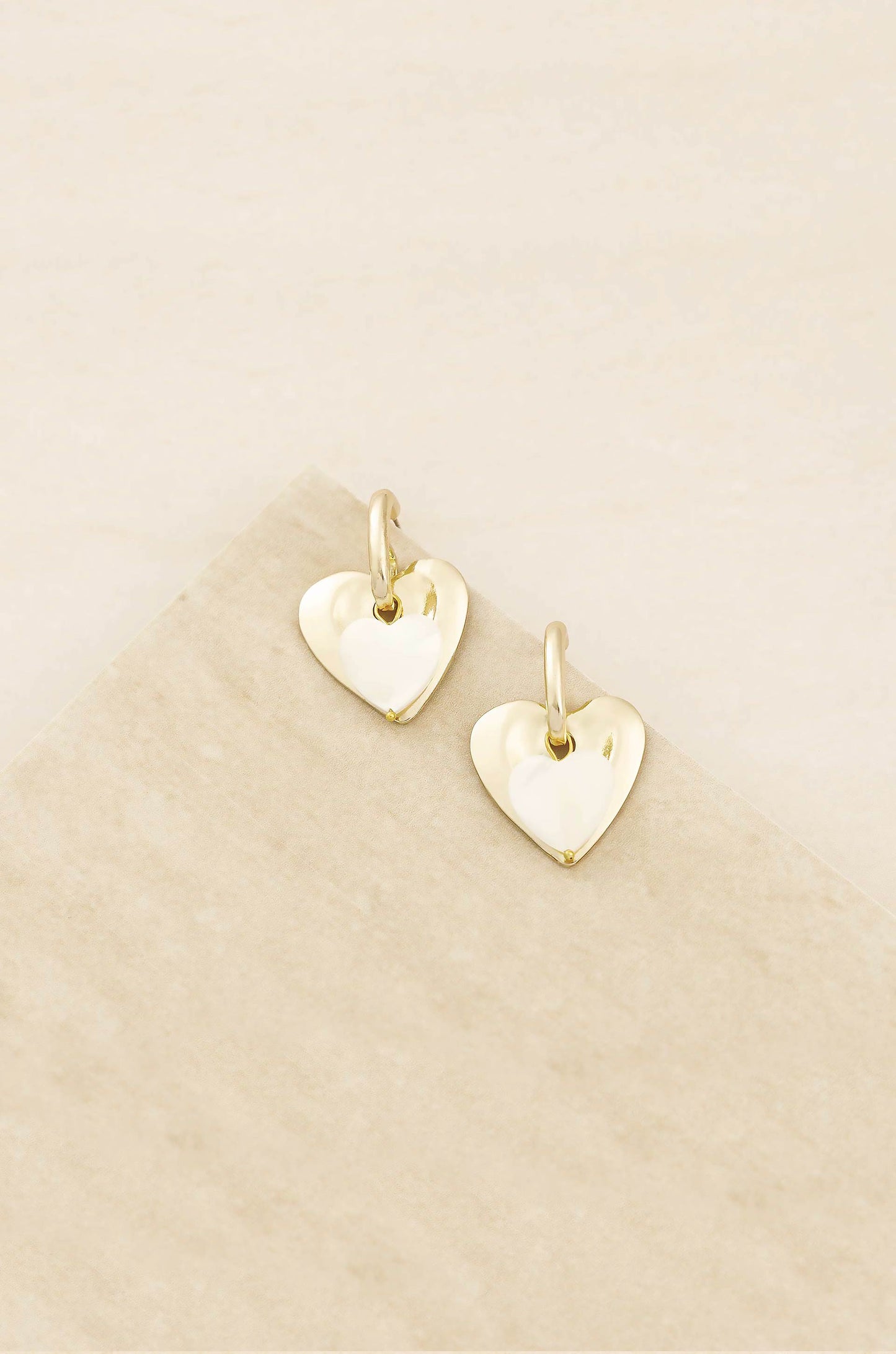 Simple Sweet Mother of Pearl and 18k Gold Plated Heart Earrings on slate background