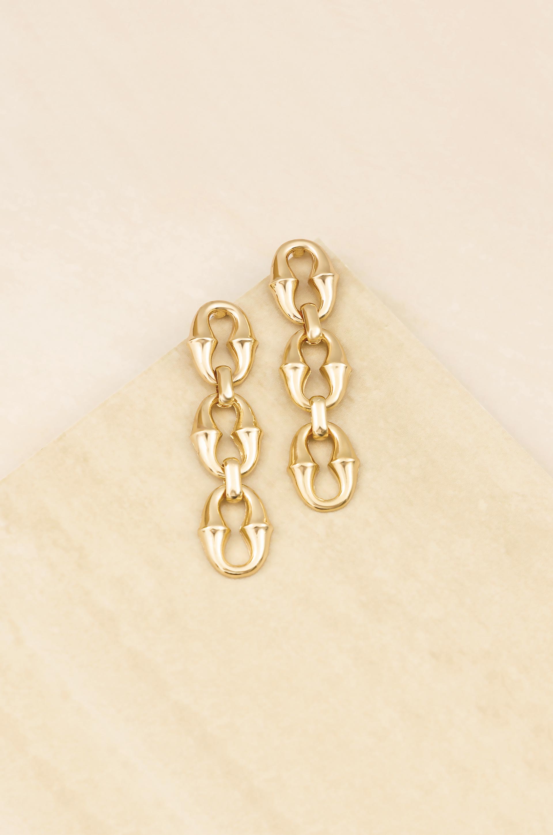 Triple Link Drop 18k Gold Plated Earrings on slate background