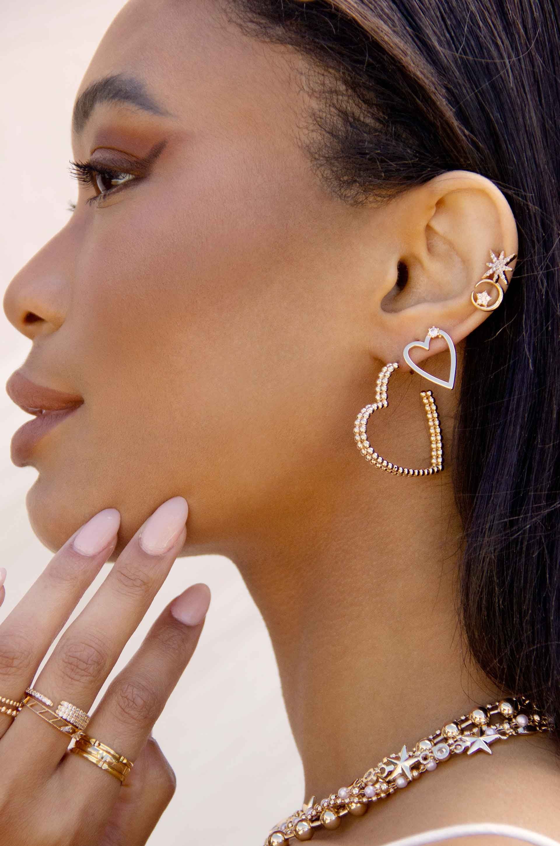 Subtle Love 18k Gold Plated Heart Earrings on a model 