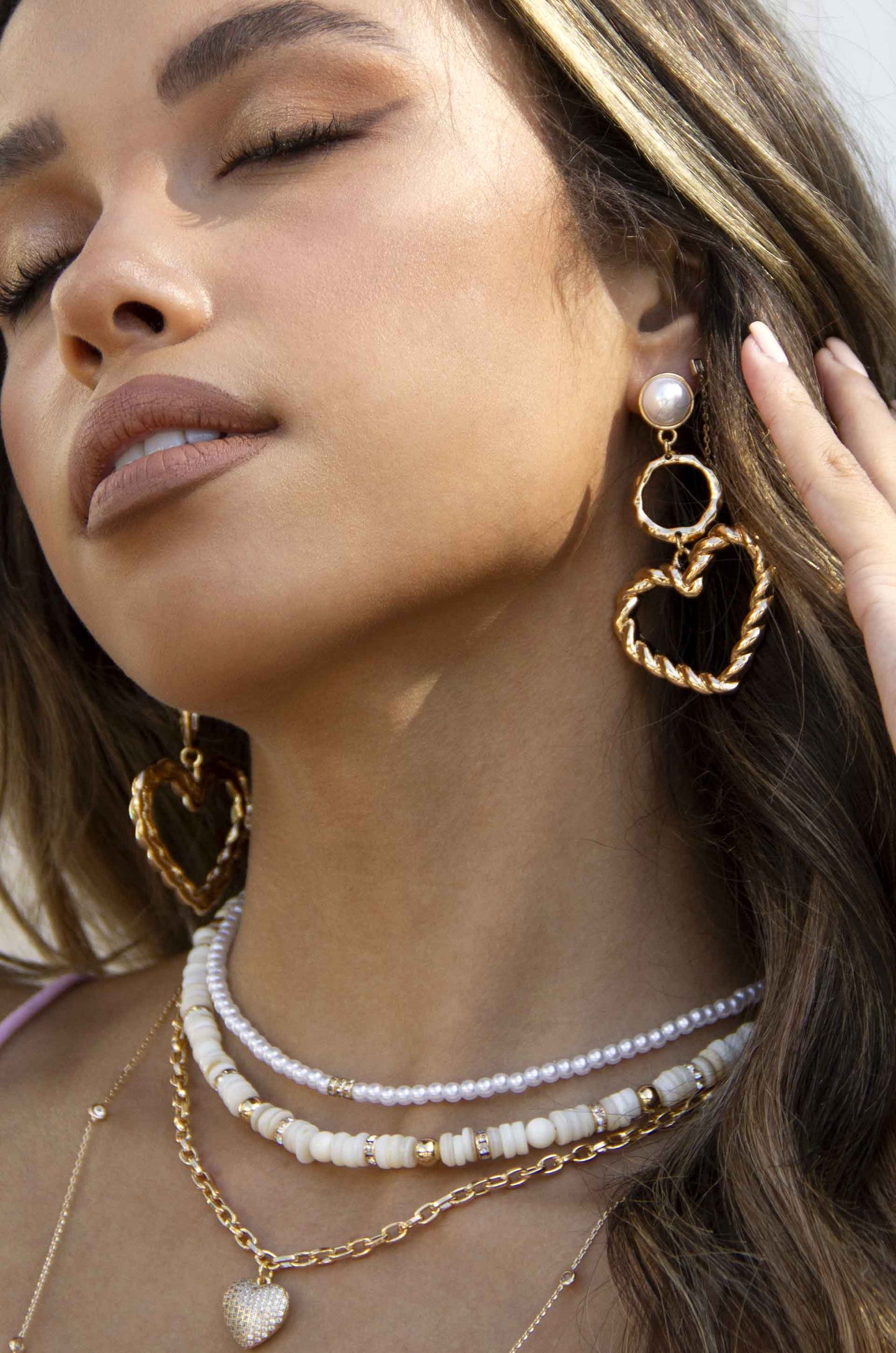 Twisted Heart Pearl and 18k Gold Plated Earrings on a model