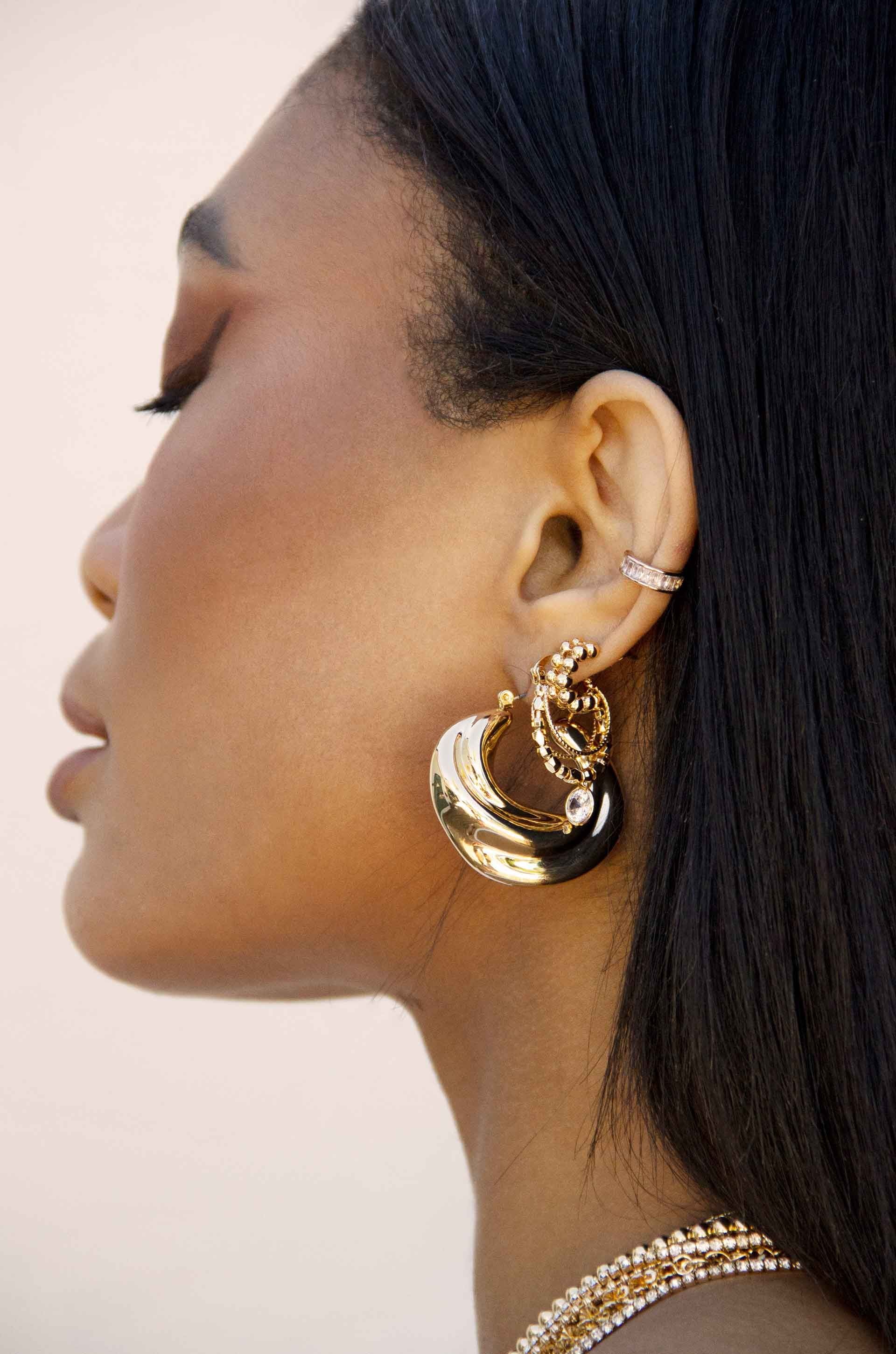 Crescent Swirl 18k Gold Plated Hoop Earrings on a model