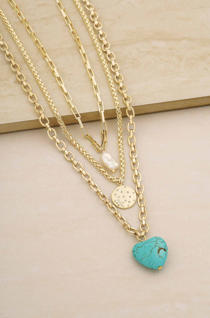 The Malibu Turquoise, Coin, and Pearl 18k Gold Plated Necklace Set on slate