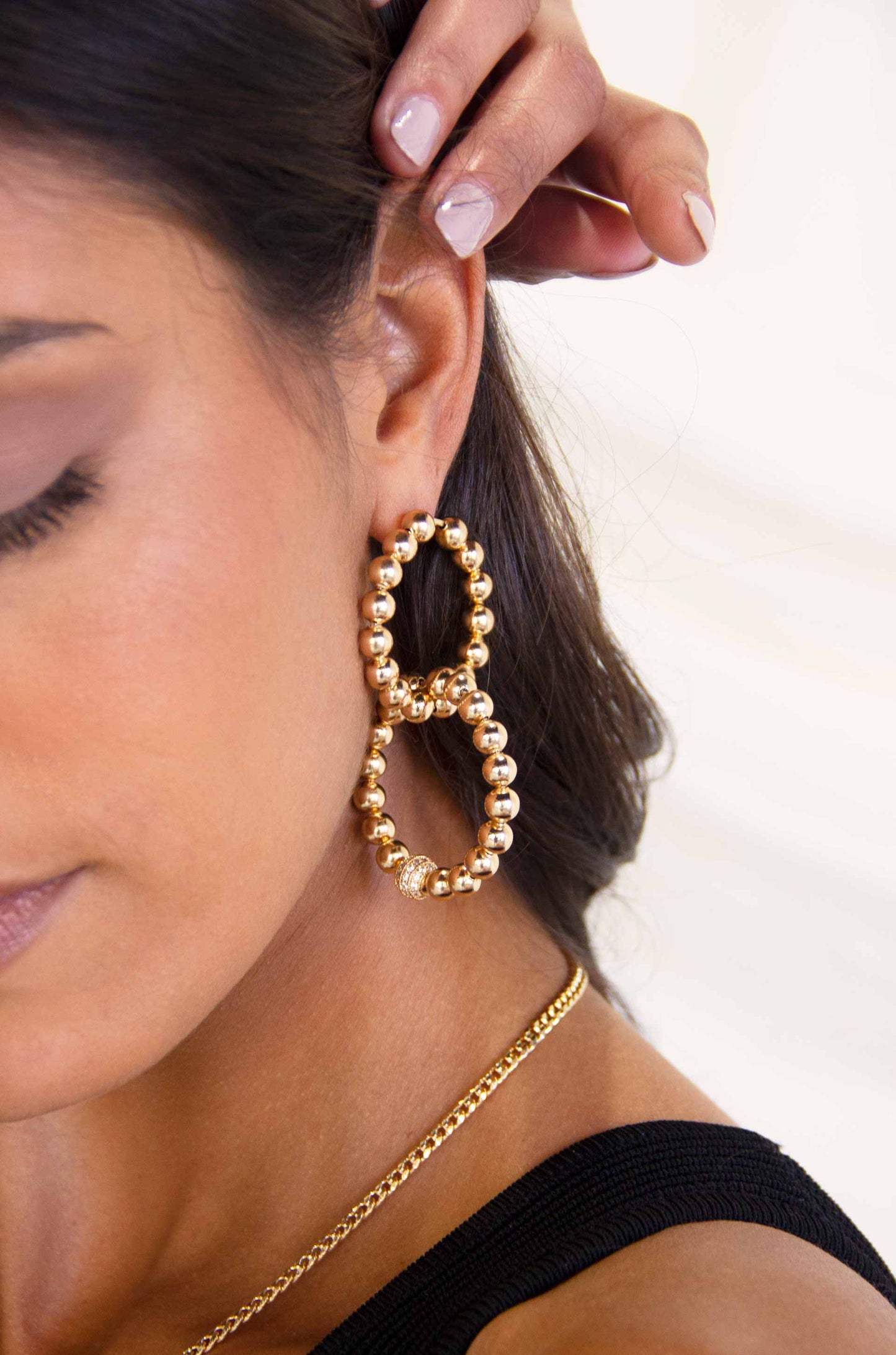 Interlocked 18k Gold Plated Ball Dangle Earrings on a model
