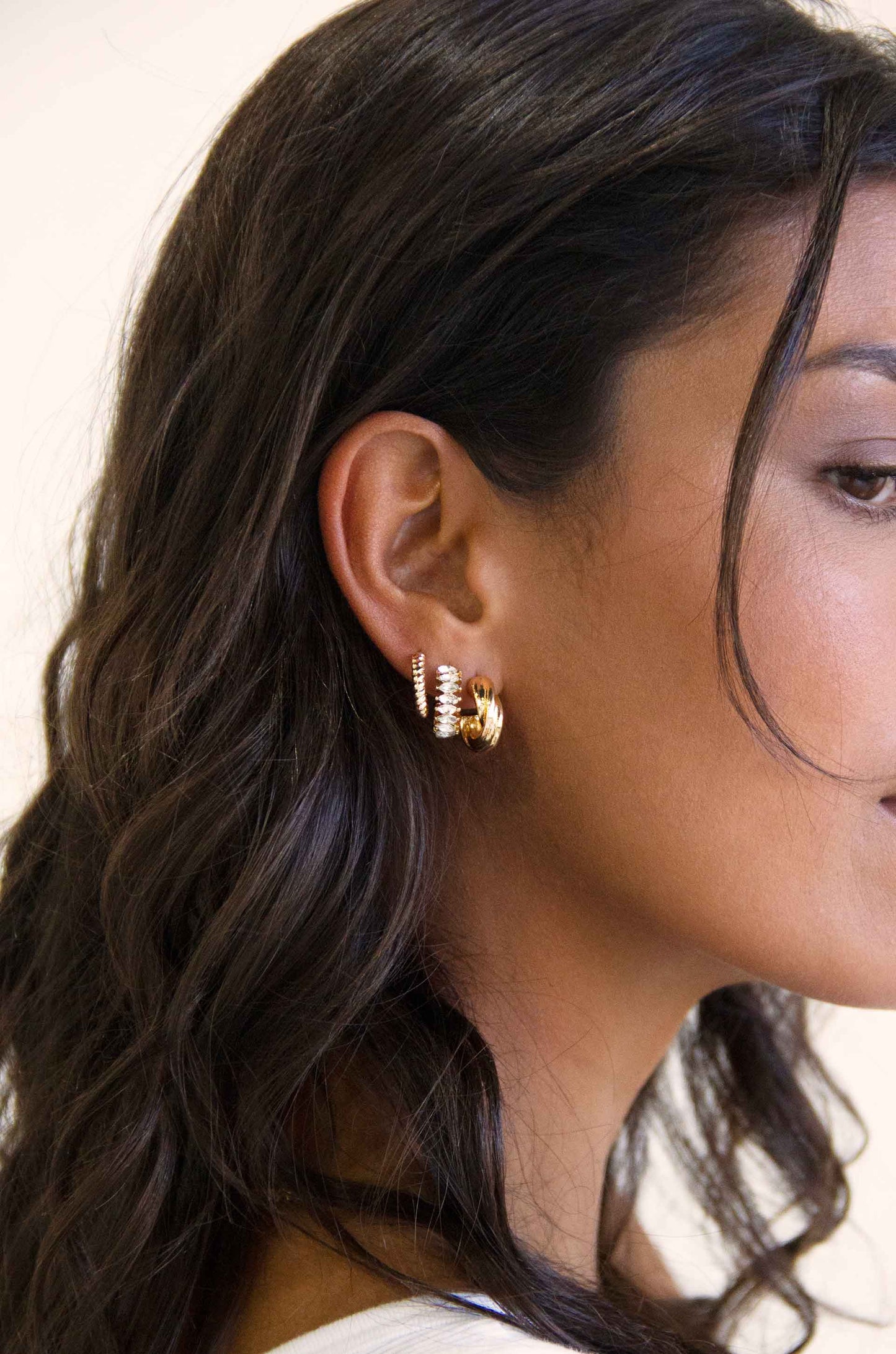 Tiny and Shiny 18kt Gold Plated Huggie Hoop Earring Set on a model