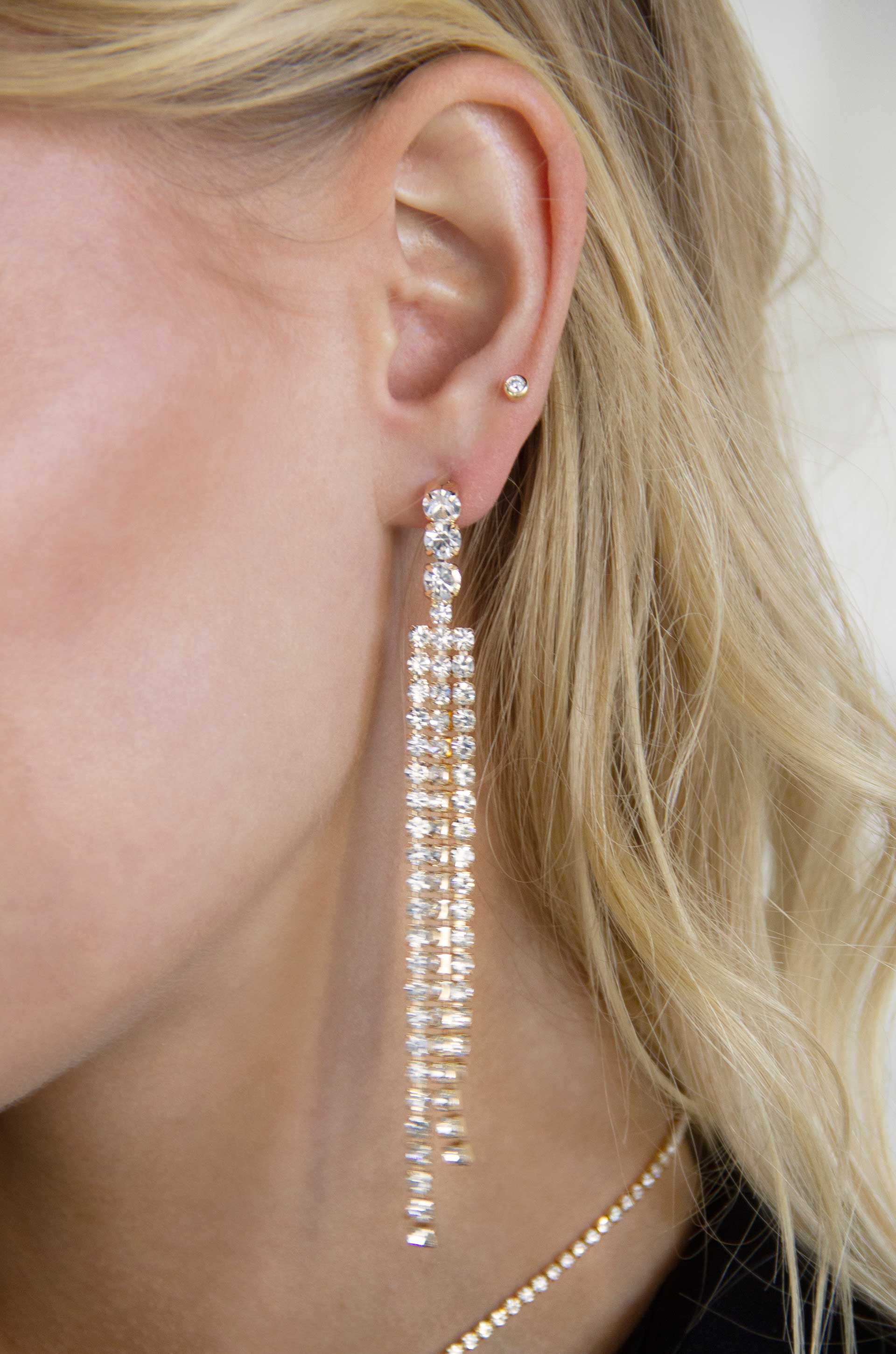 The Moment 18k Gold Plated Crystal Dangle Earrings on a model
