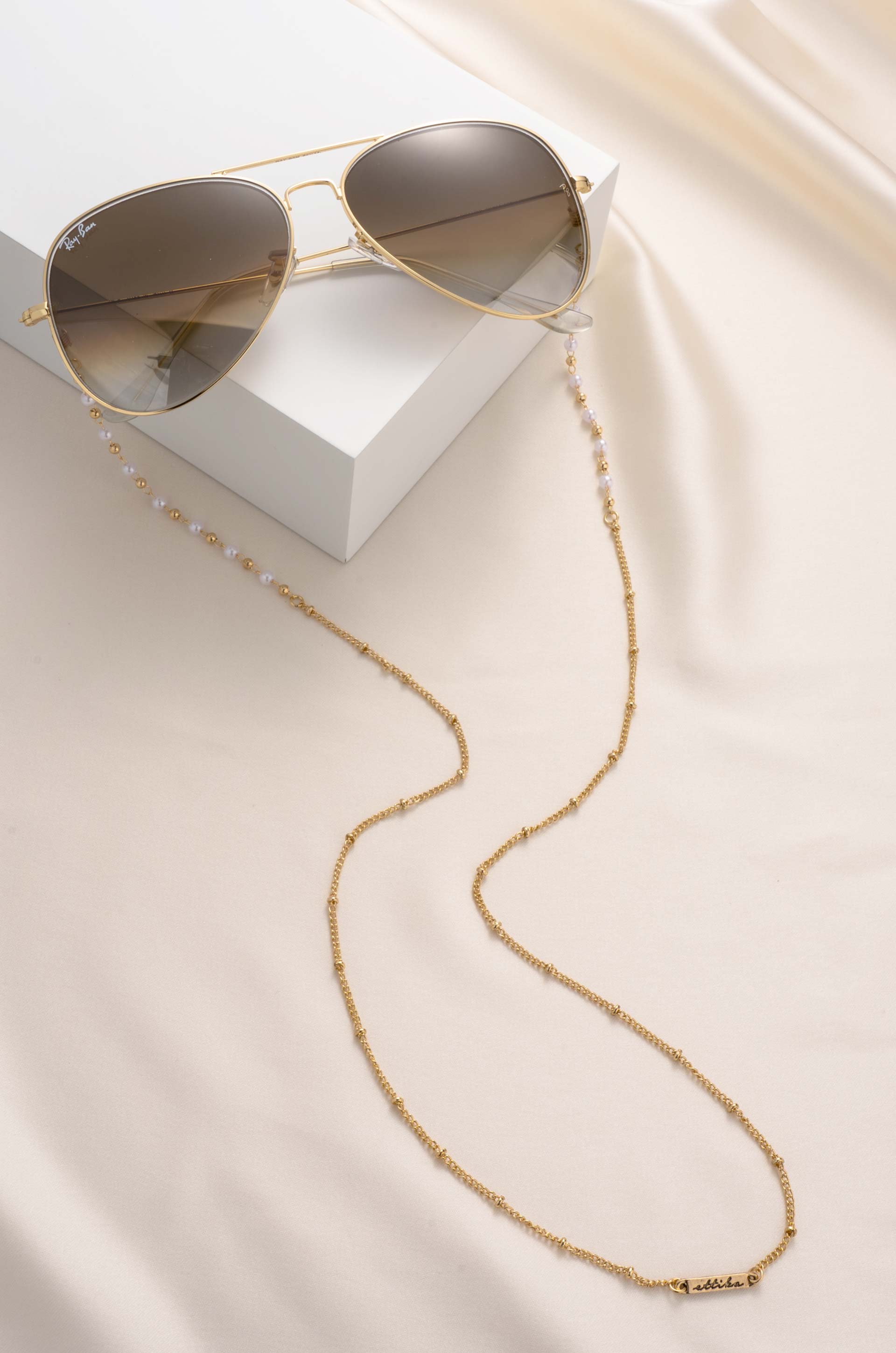 Dainty Pearl and Gold Glasses Chain on slate