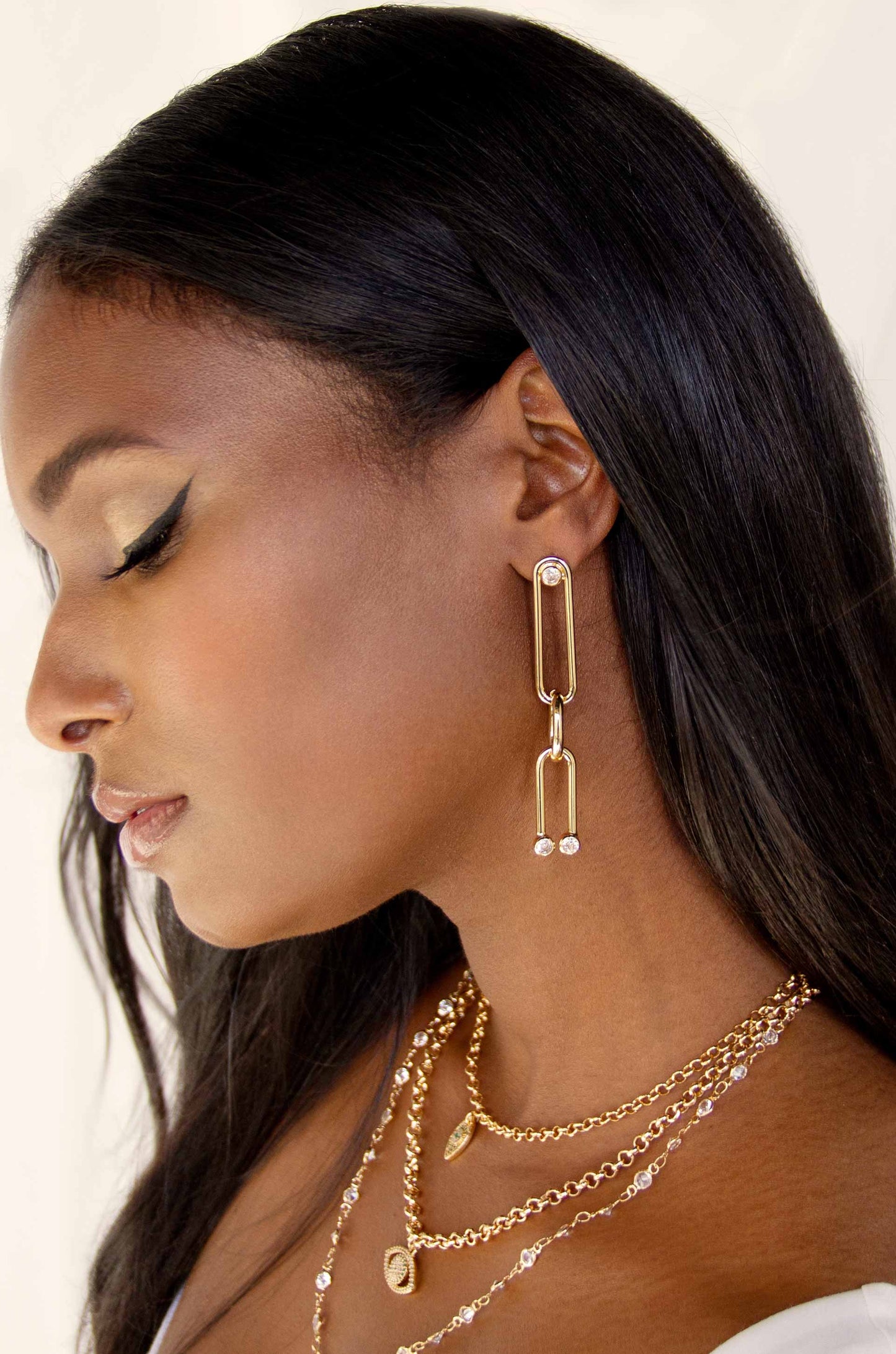 Crystal Spotted 18k Gold Plated Linked Dangle Earrings on a model