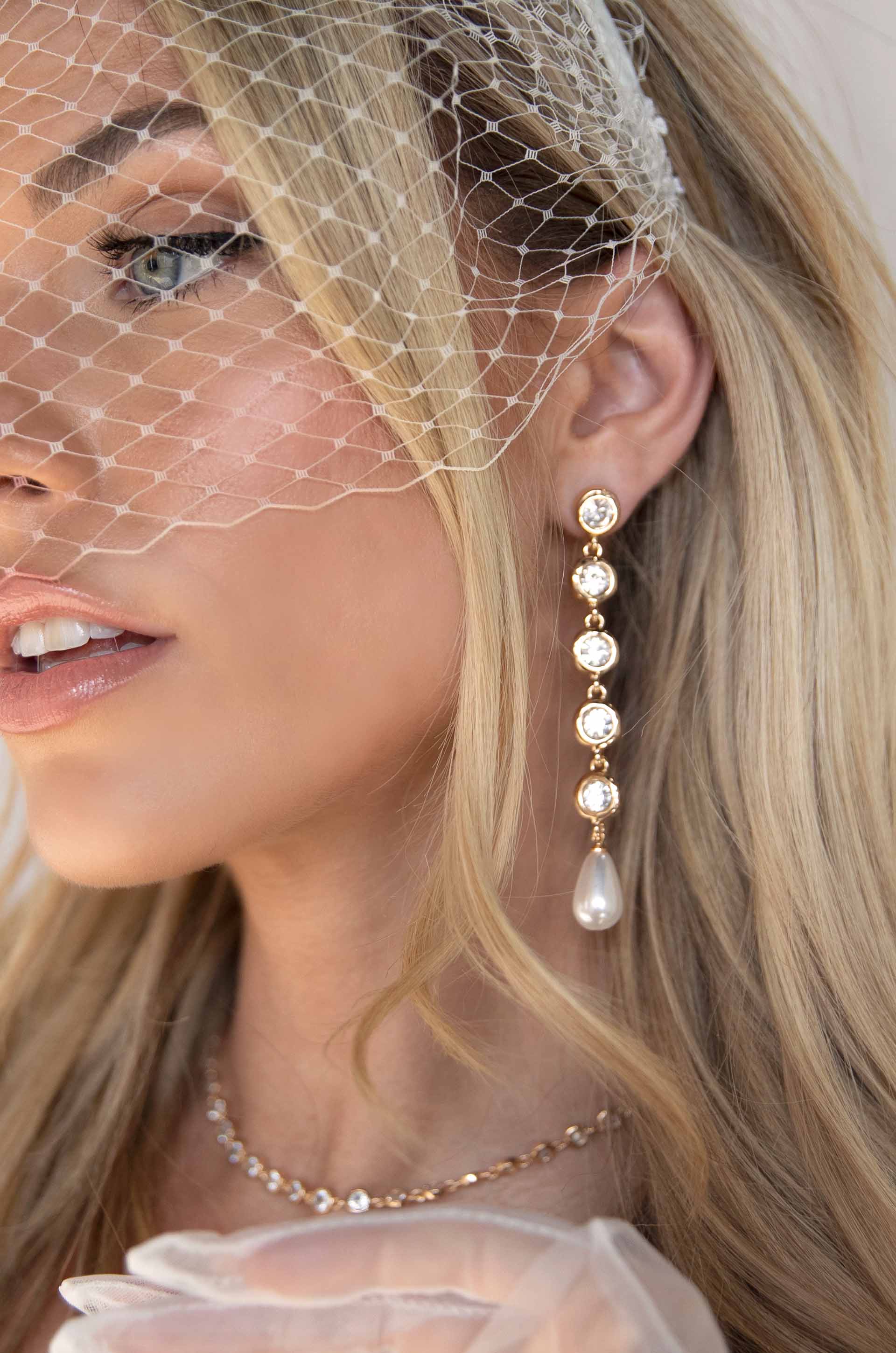 Elegantly Modern Crystal and Pearl 18k Gold Plated Dangle Earrings on a model