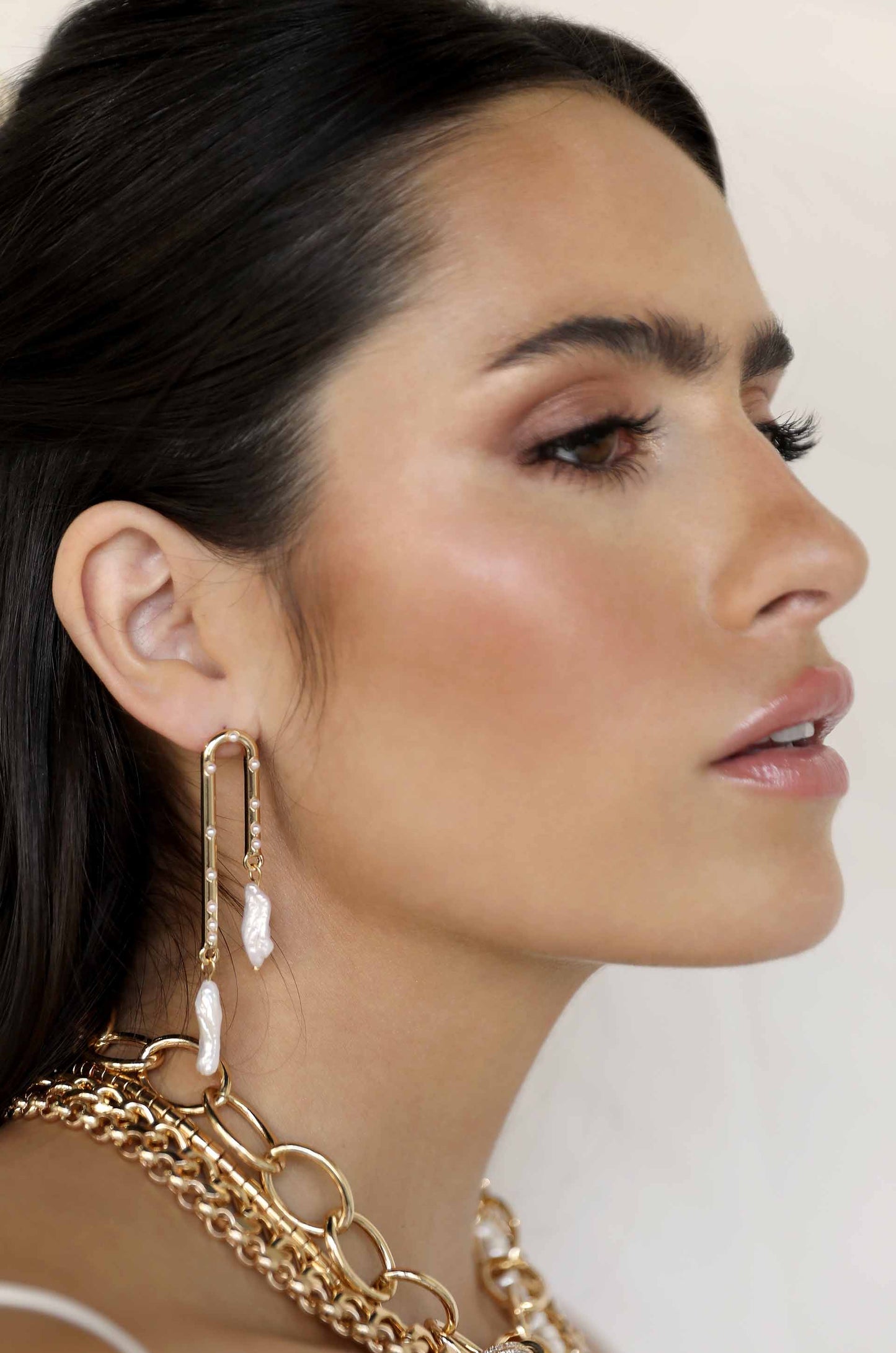 Asymmetrical Pearl Dangle 18k Gold Plated Earrings on a model