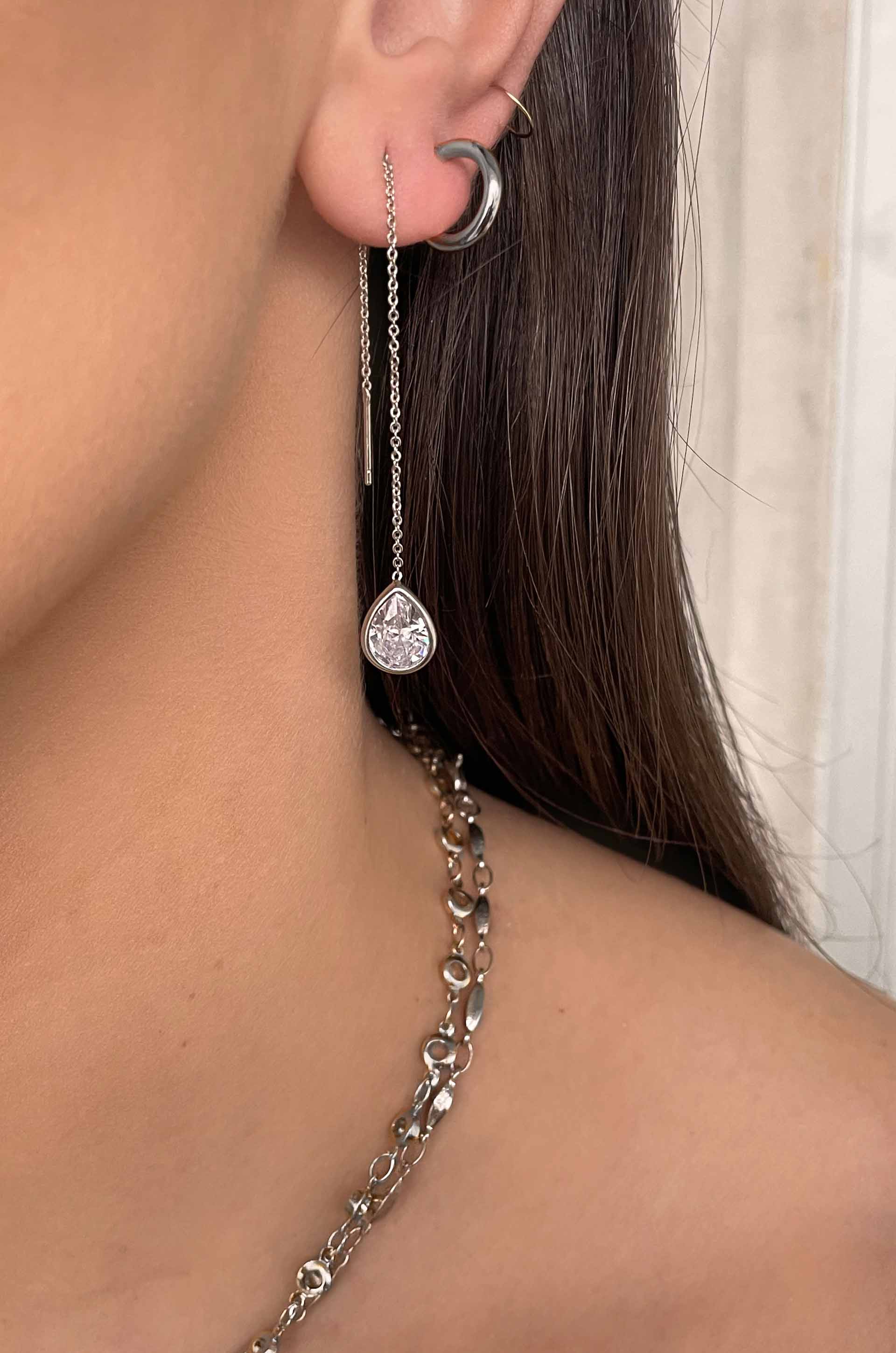 Barely There Chain and Crystal Dangle Earrings on a model in rhodium