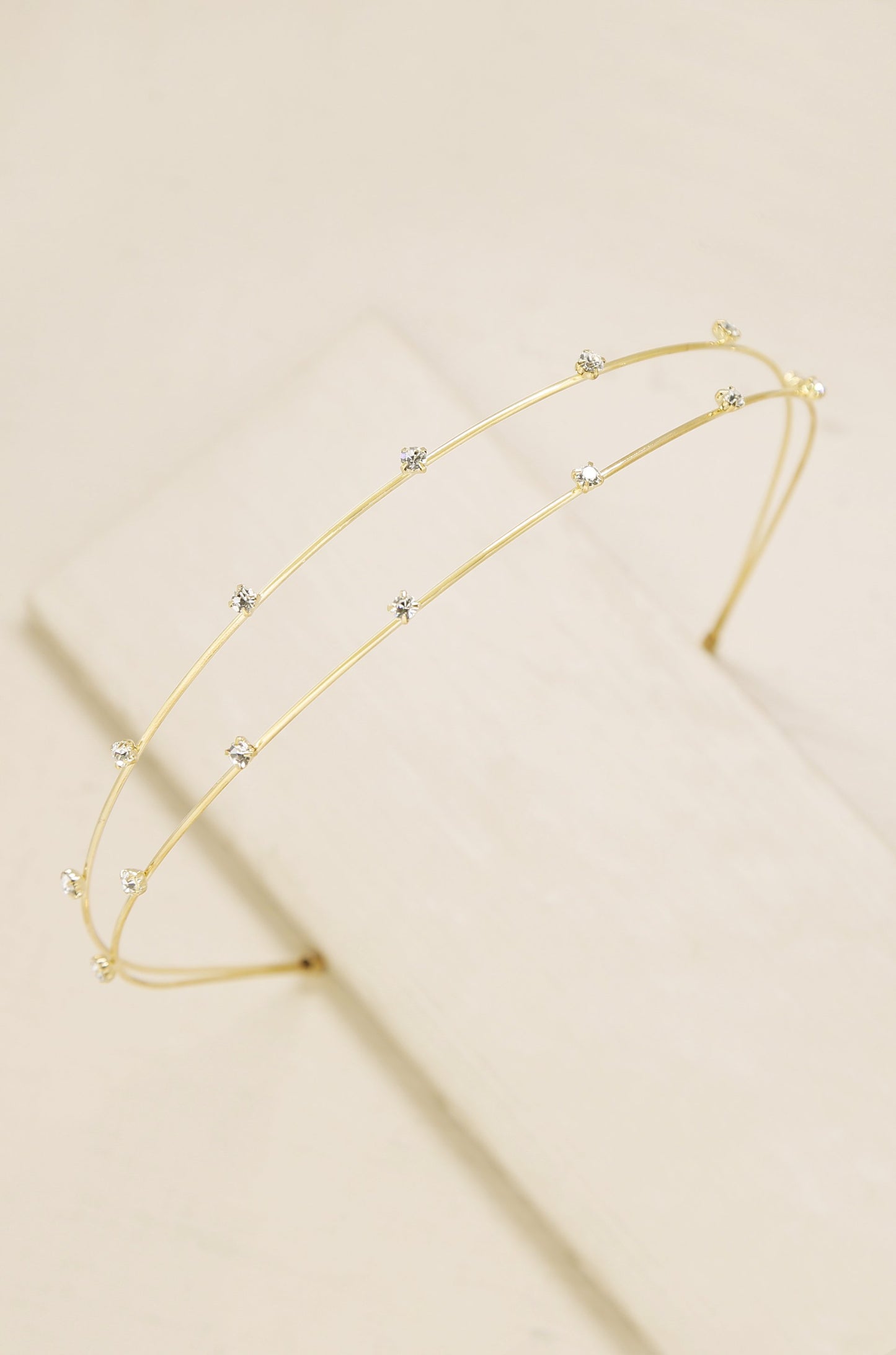Delicate Crystal Dotted Gold Headband on slate background  