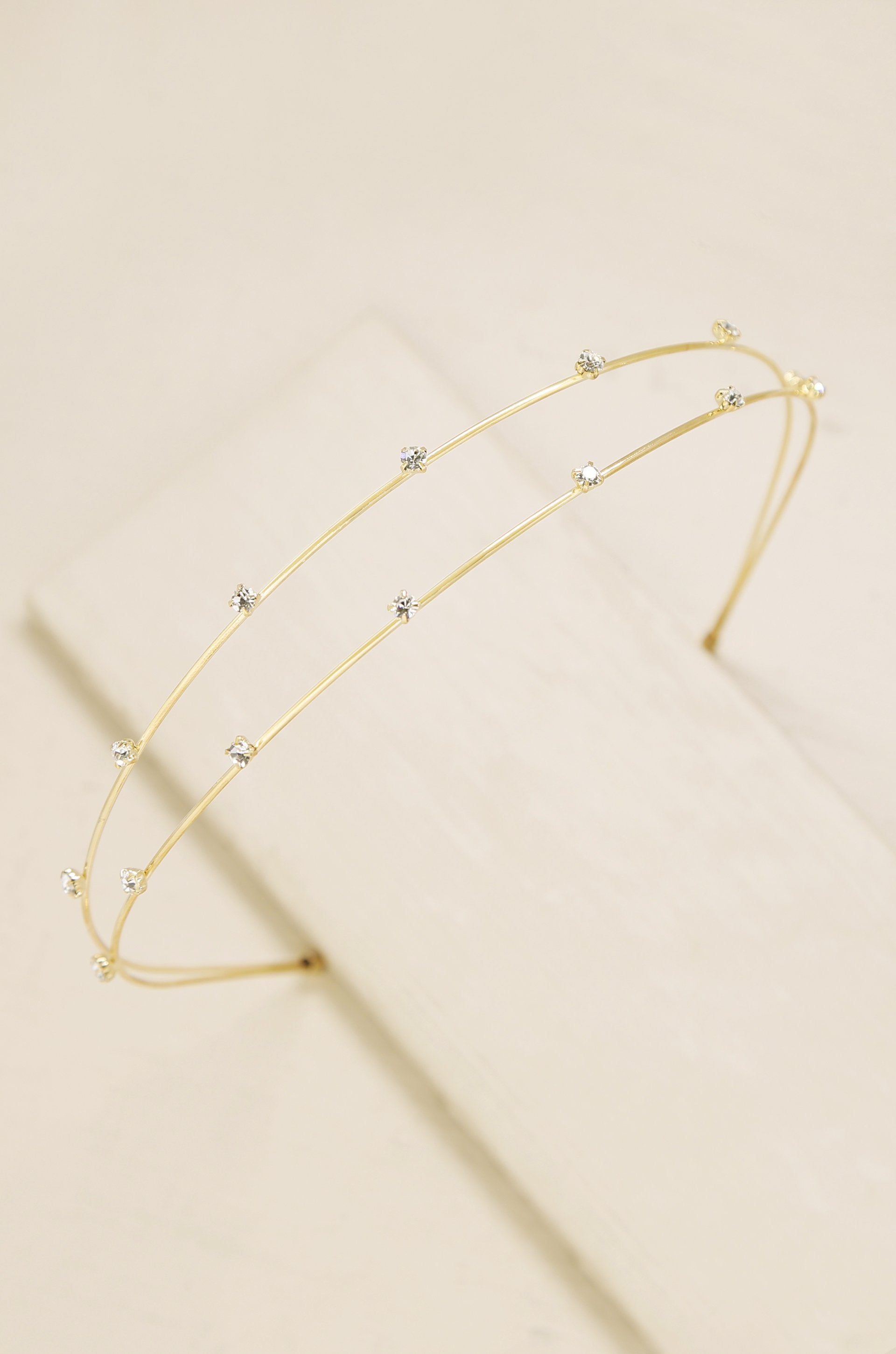 Delicate Crystal Dotted Gold Headband on slate background  
