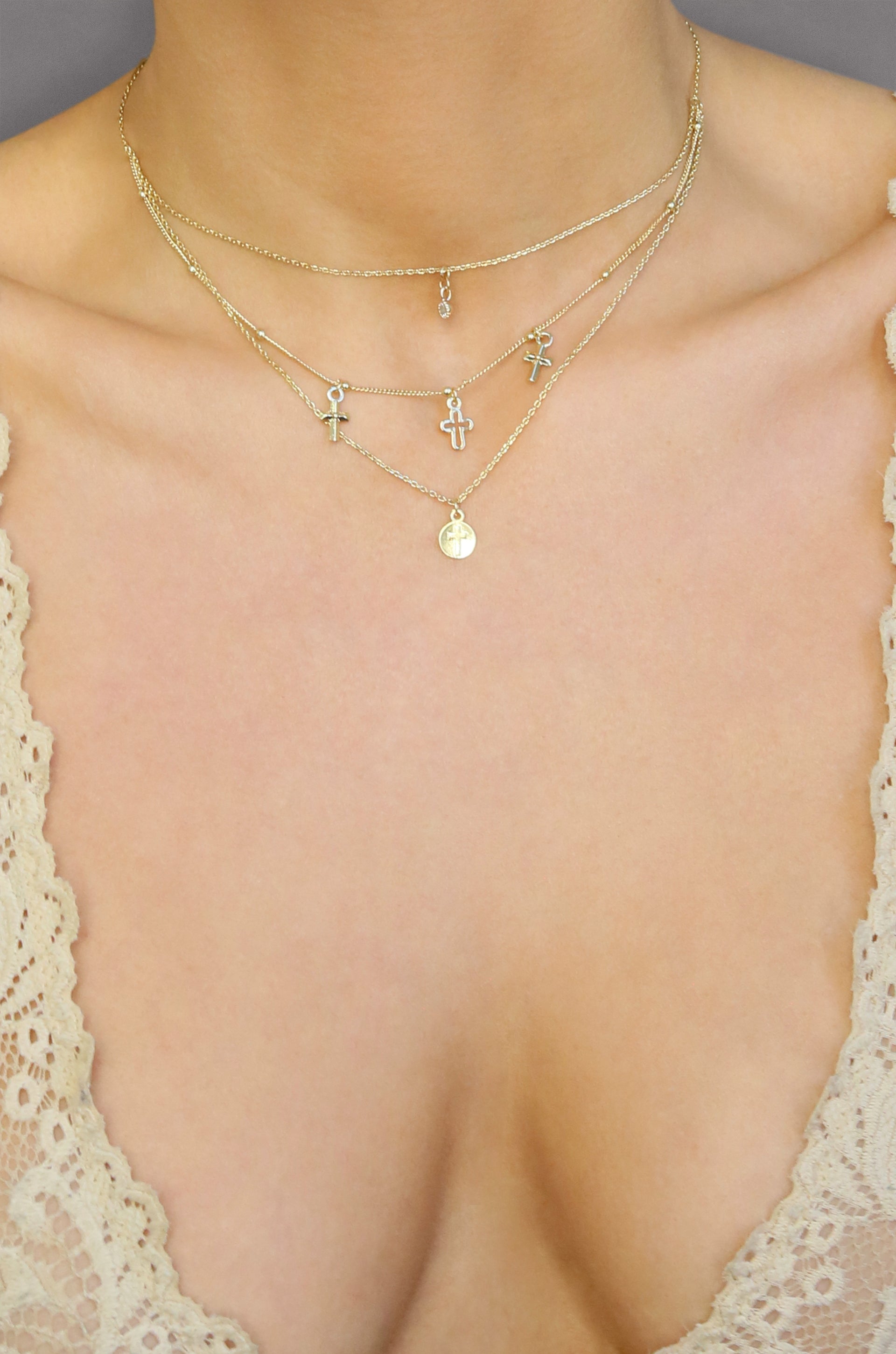 Pray it Forward 18k Gold Plated Layered Cross Necklace shown on a model  