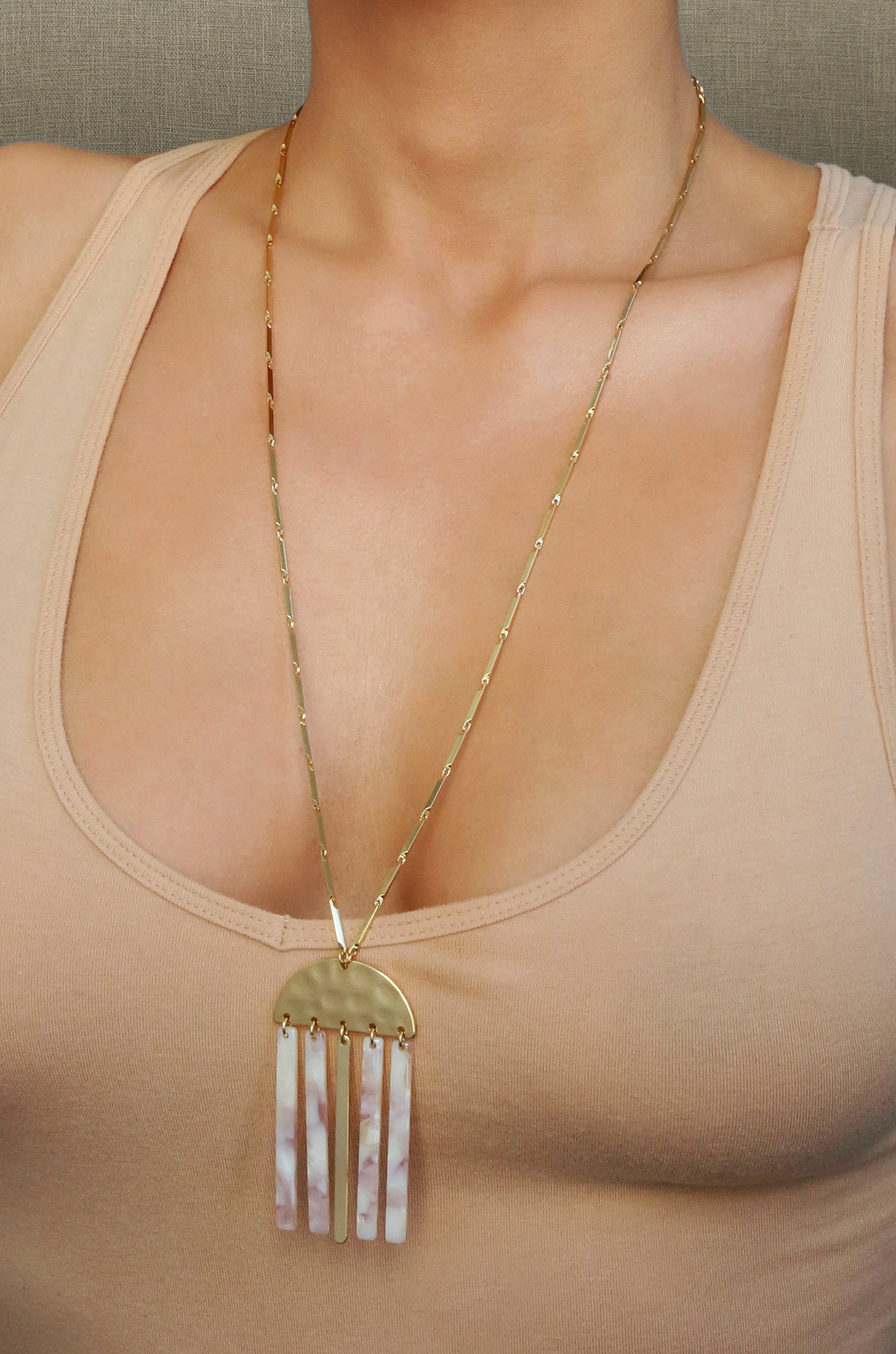 Golden Goddess Geometric Pendant 18k Gold Plated Necklace with Taupe Resin Bars shown on a model  