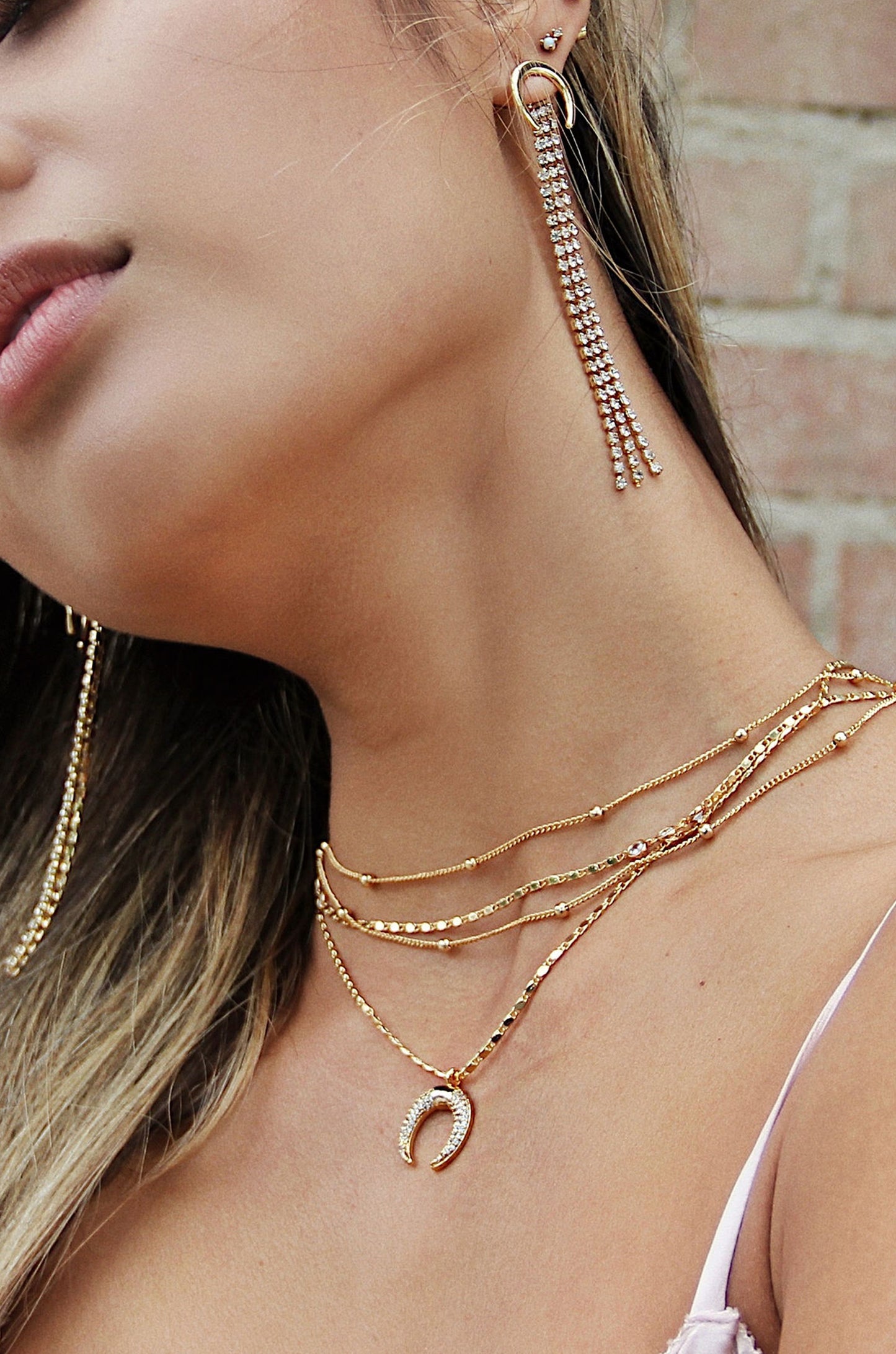 Layered Gold Chain & Crescent Horn Necklace  shown on a model  