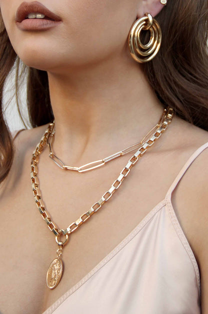The Traveler's Coin 18k Gold Plated Chain Necklace shown on a model  