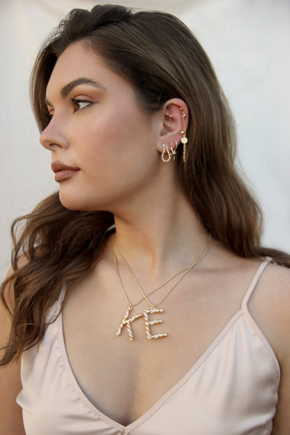 Letters K and E Twisted Crystal Initial 18k Gold Plated Necklace shown on a model
