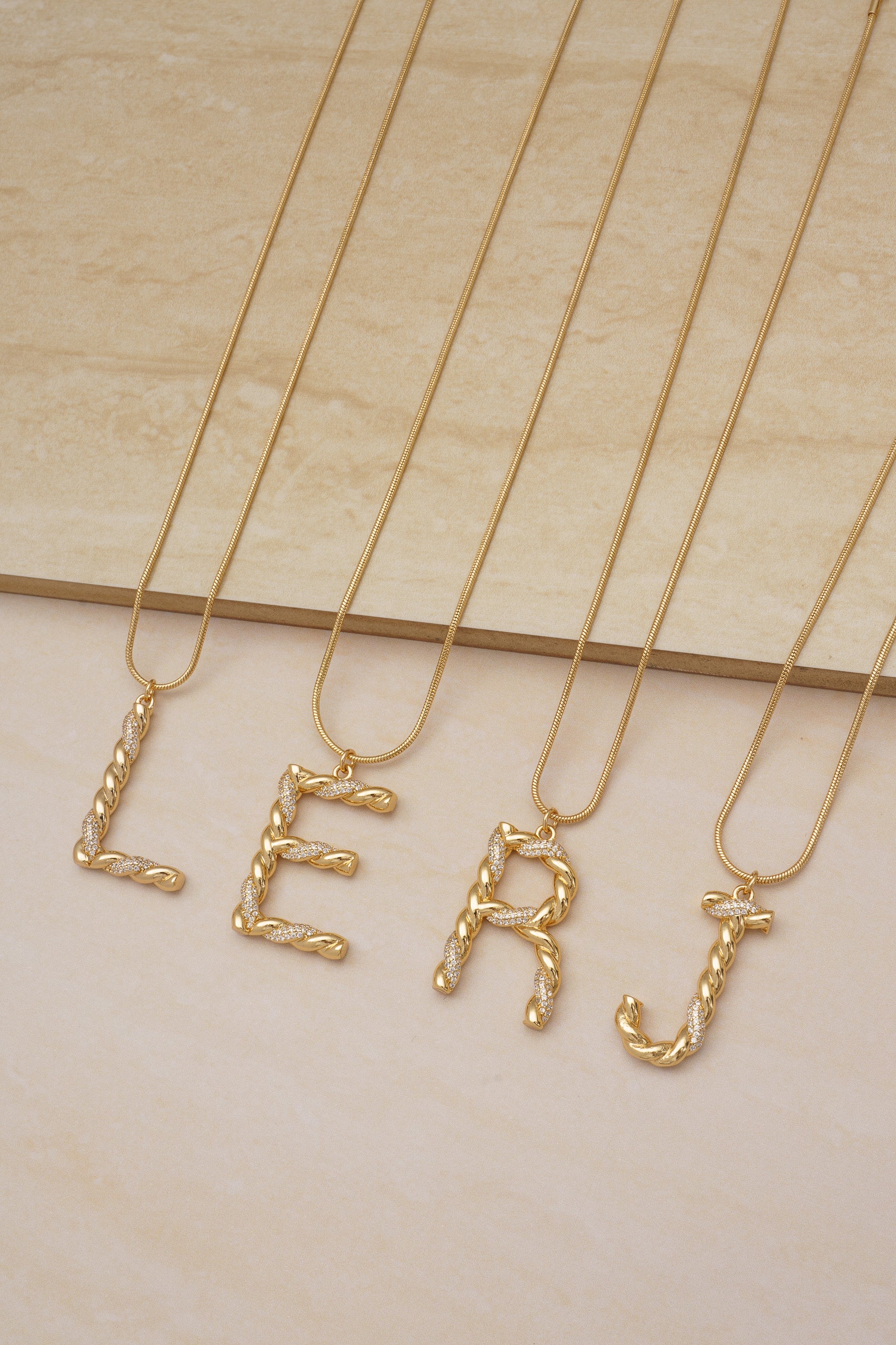 Group Photo of Twisted Crystal Initial 18k Gold Plated Necklaces