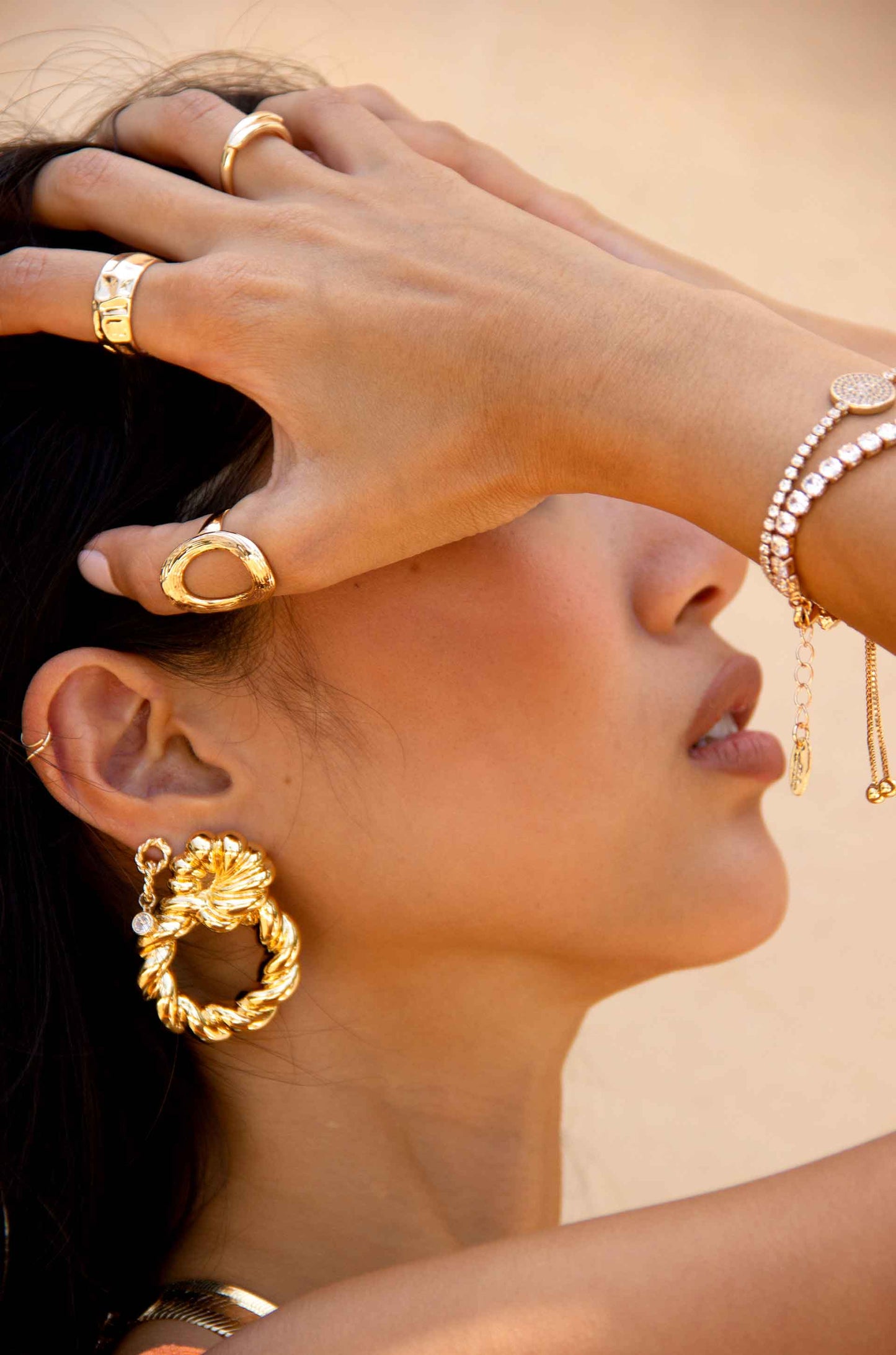 Twist and Shout 18k Gold Plated Textured Earrings on a model