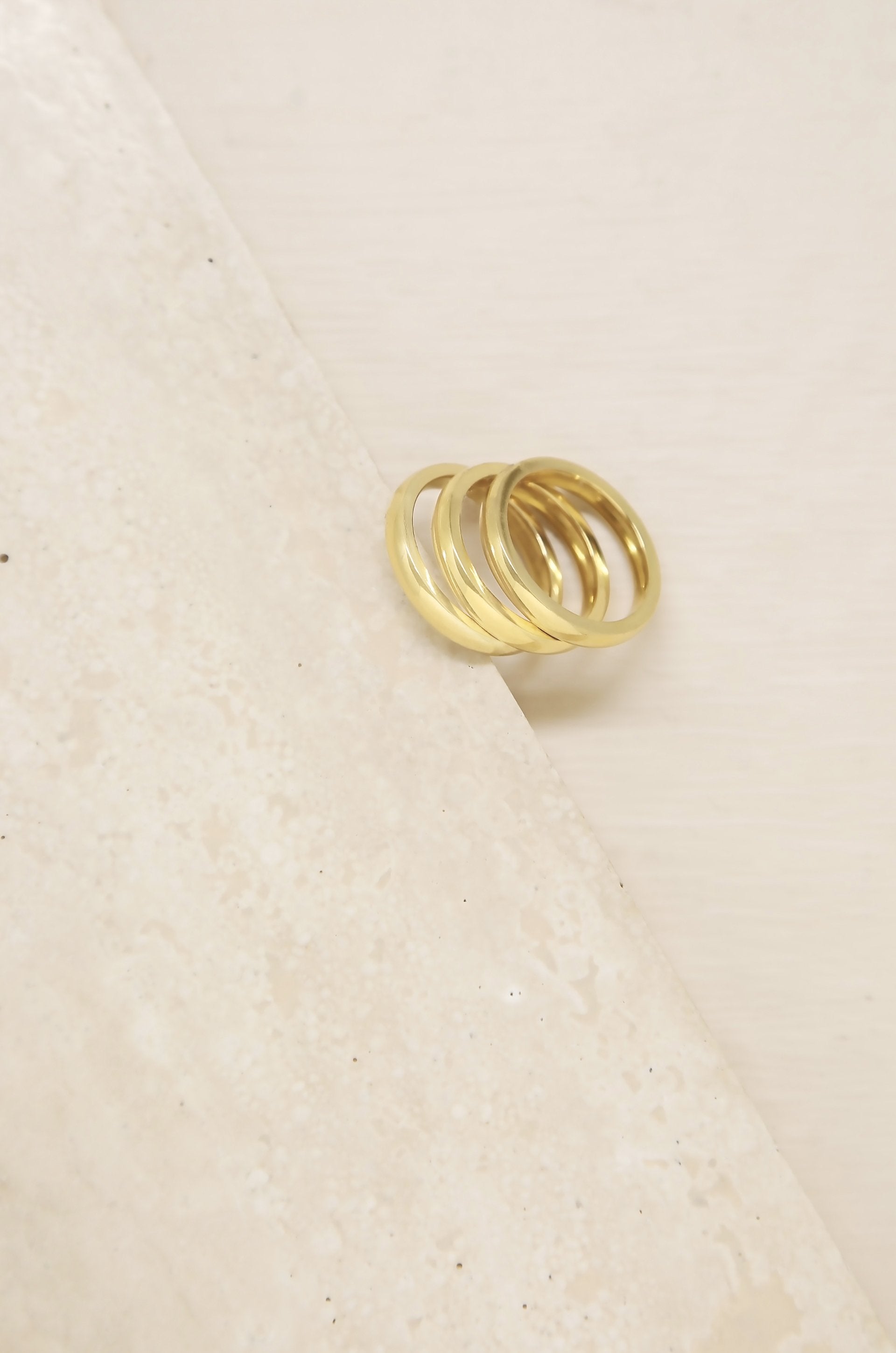 Back to Basics 18k Gold Plated Ring Set of 3 on slate background  