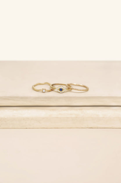 Dainty Crystal Trio 18k Gold Plated Ring Set on slate background  