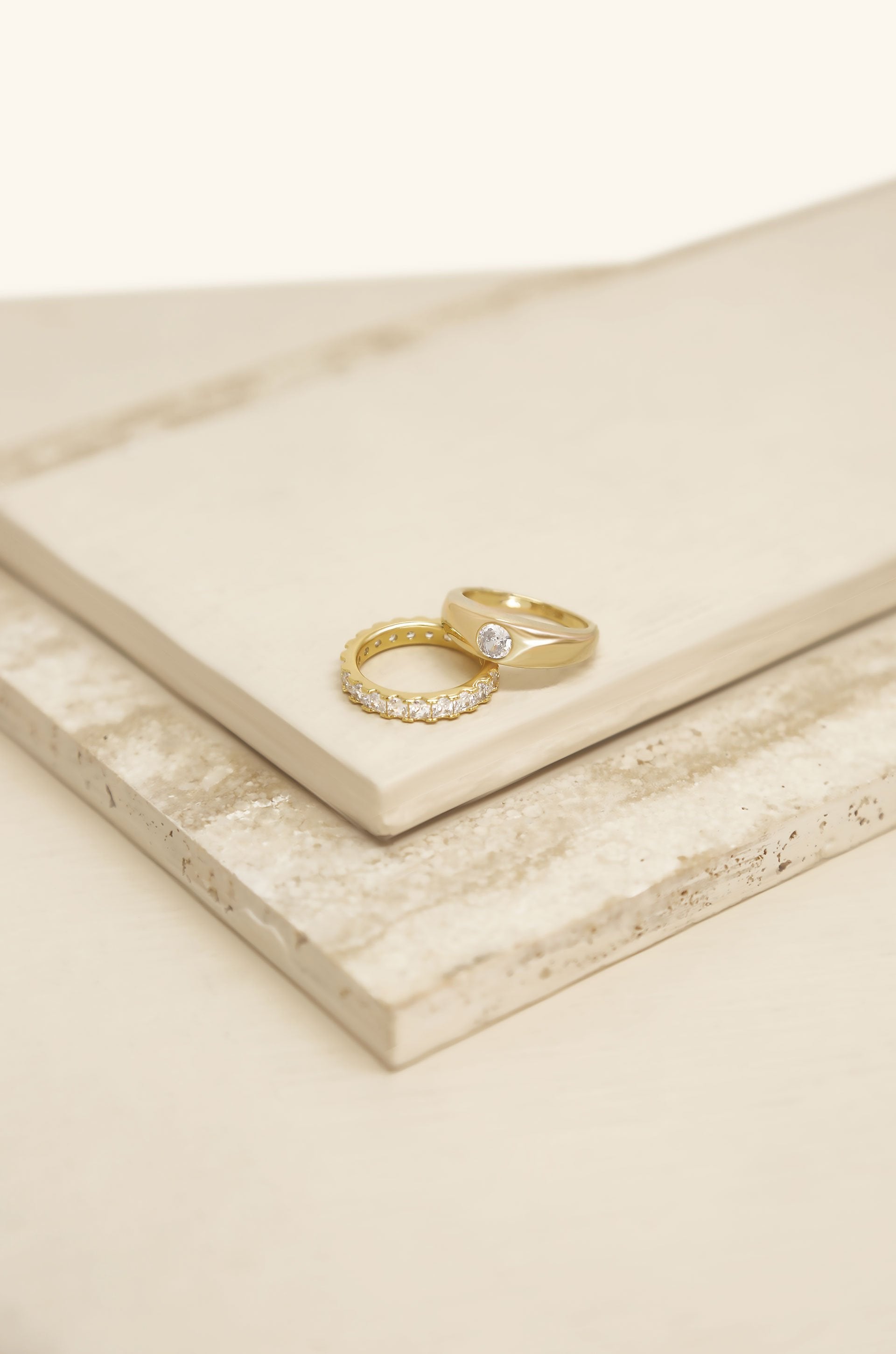 Simple Touch Crystal & 18k Gold Plated Ring Set on slate background  